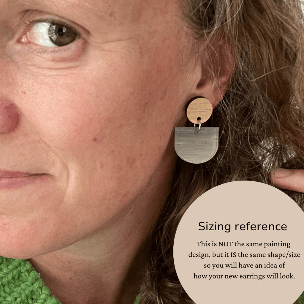 Liv wearing a pair of her hand painted earrings to show how the Scallop Dangle Style earring looks being worn.